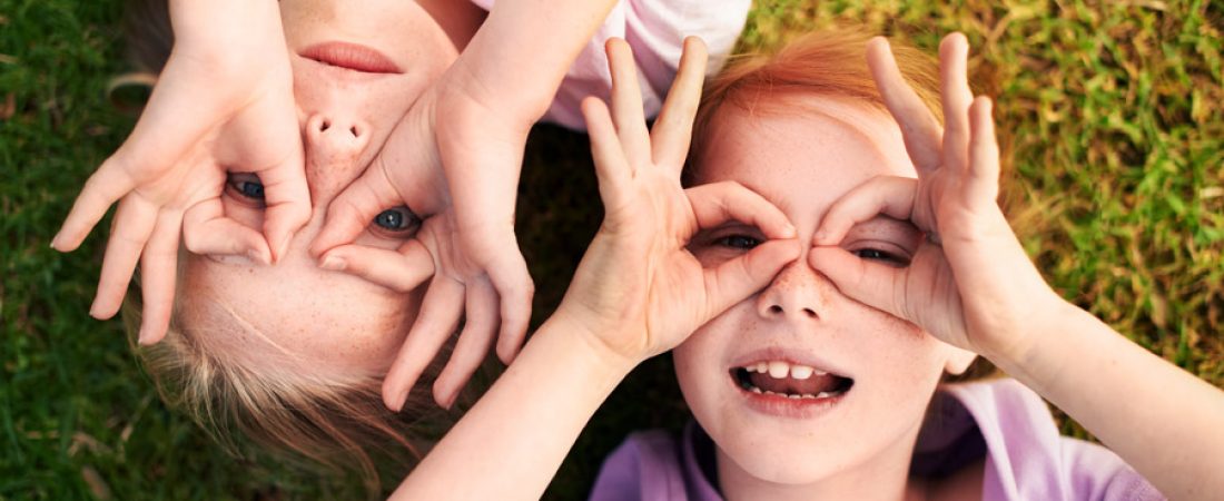Two happy children having fun while highlighting the importance of eye and eyelid hygiene in children